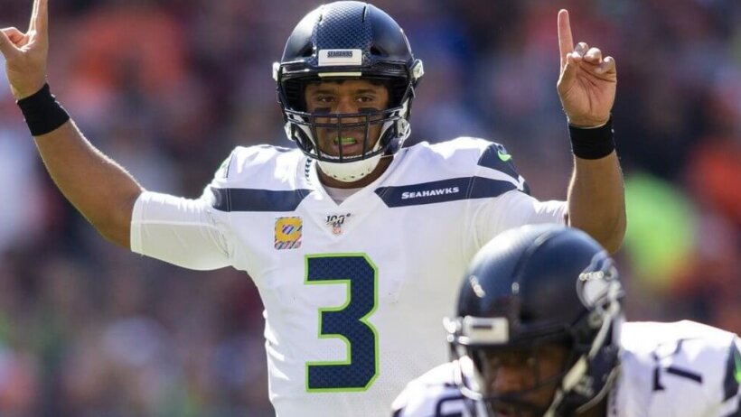 Russell Wilson signaling at the line of scrimmage