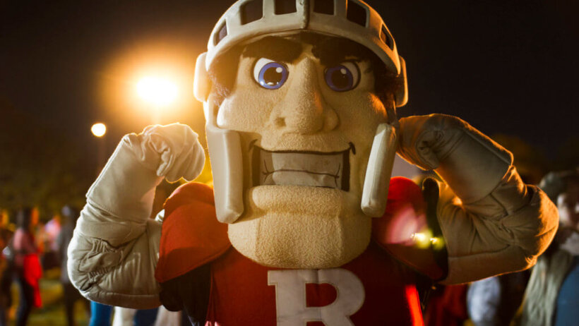 The Rutgers football mascot flexing.