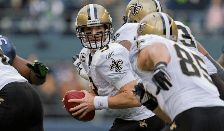 Saints QB Drew Brees handing the ball off.