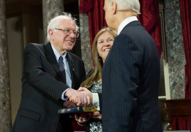 Bernie Sanders and Joe Biden shaking hands.