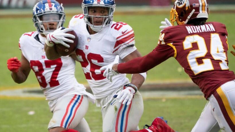 NY Giants RB Saquon Barkley eludes Josh Norman of Washington