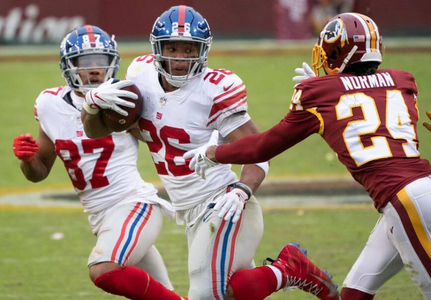 NY Giants RB Saquon Barkley eludes Josh Norman of Washington