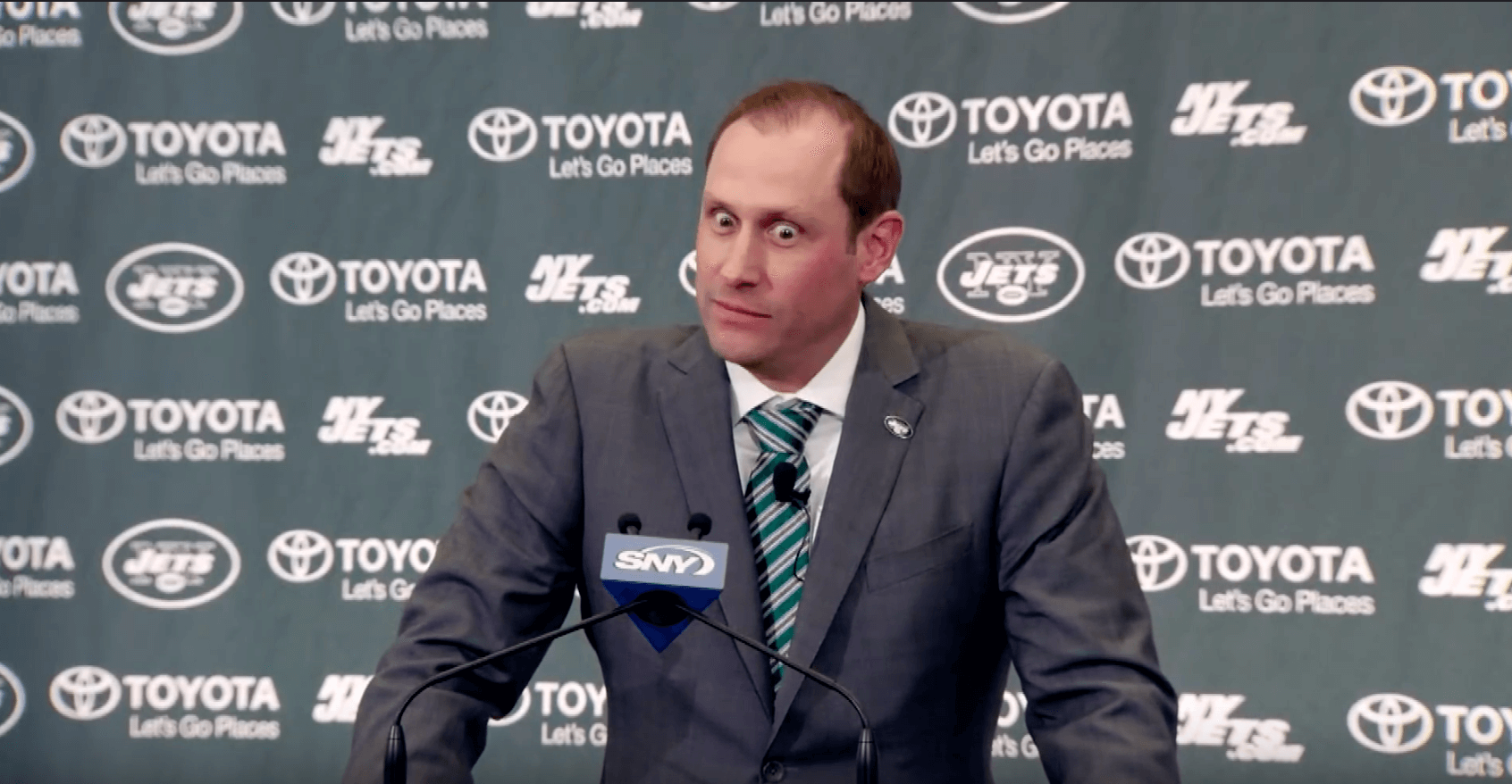 Adam Gase making odd faces at the podium