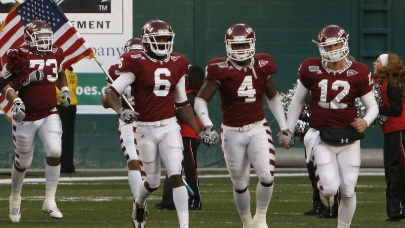 The Temple Owls Football team takes the field