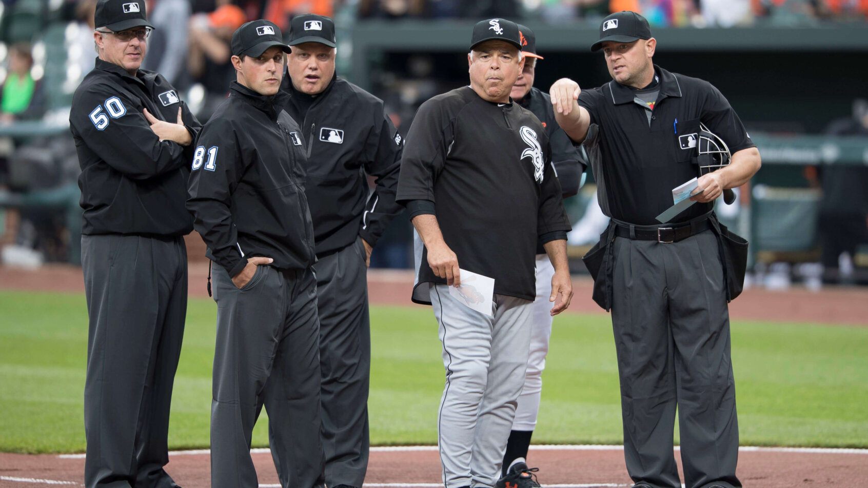 White Sox manager Rick Renteria talks with the umpires