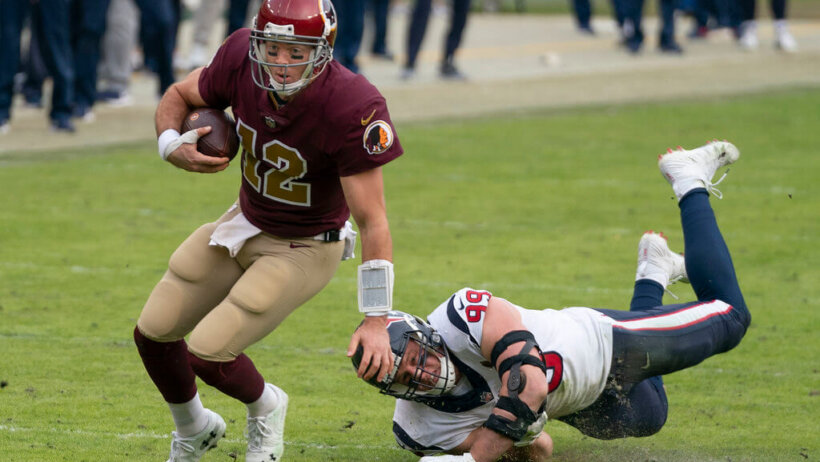 Colt McCoy avoids J.J. Watt.