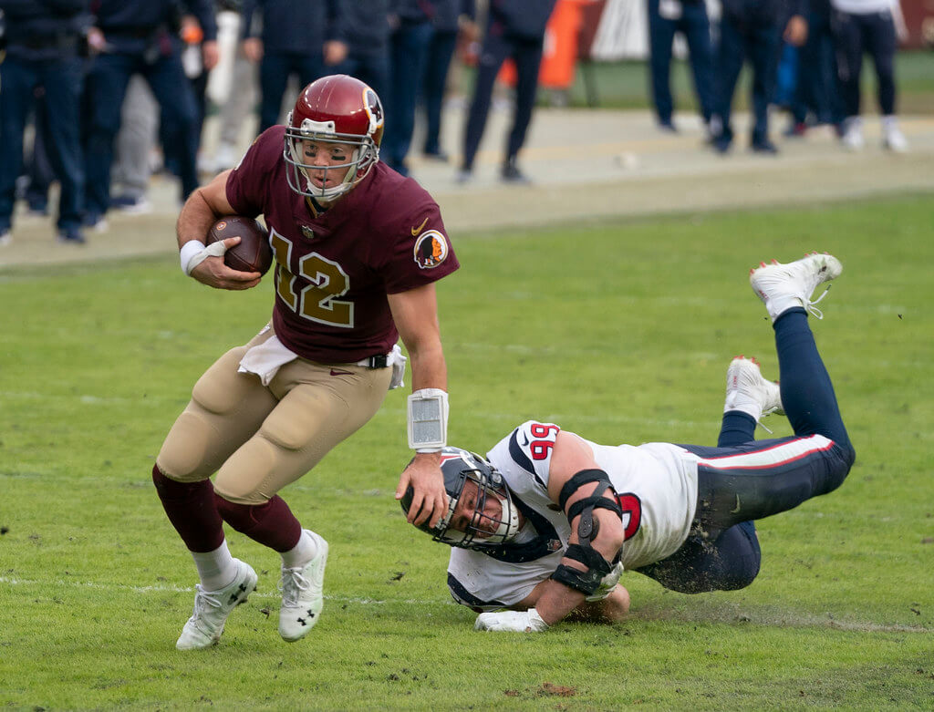 Colt McCoy avoids J.J. Watt.