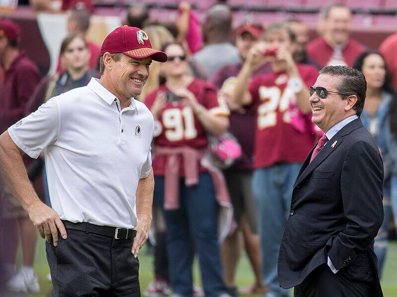 Washington Redskins owner Daniel Snyder smiling on sidelines.