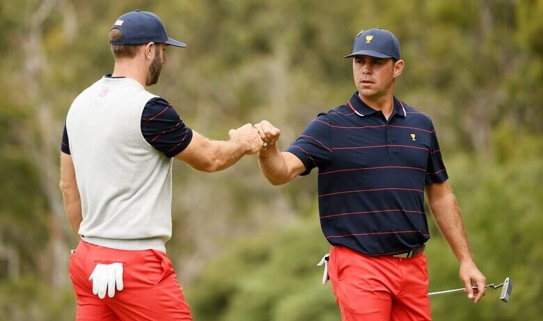 Dustin Johnson and Gary Woodland fist dab
