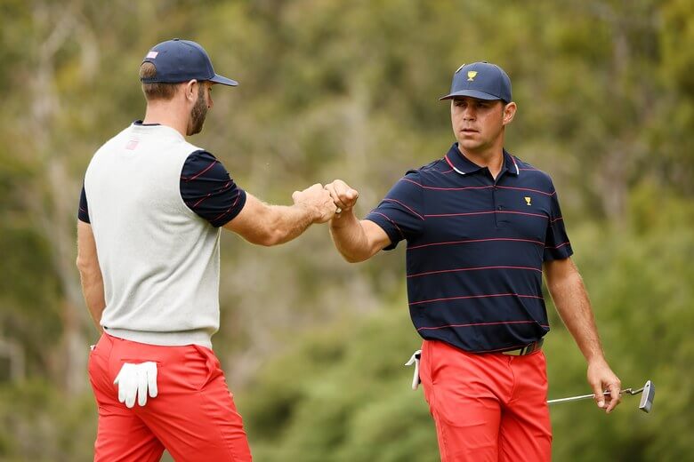 Dustin Johnson and Gary Woodland fist dab