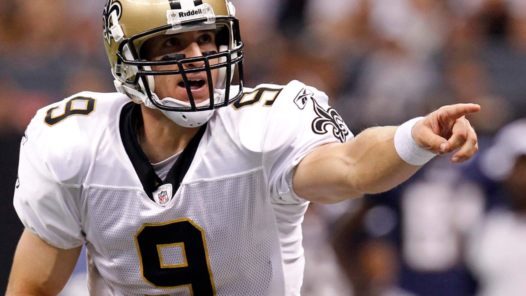 New Orleans Saints quarterback Drew Brees calling a play at the line of scrimmage during a game.