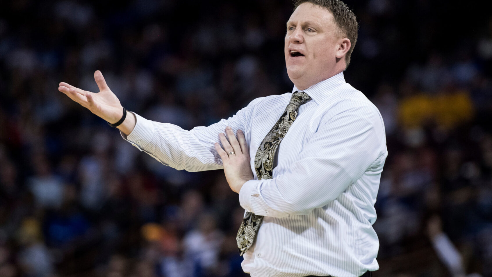 Mike Rhoades speaking with one arm up