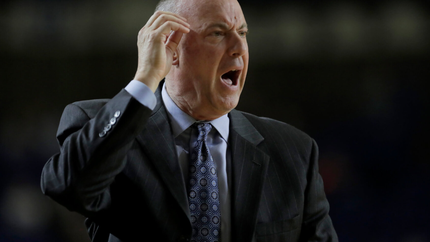Navy head coach Ed DeChellis pointing at head