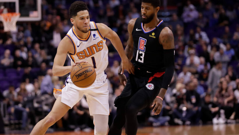 Devin Booker driving against Paul George