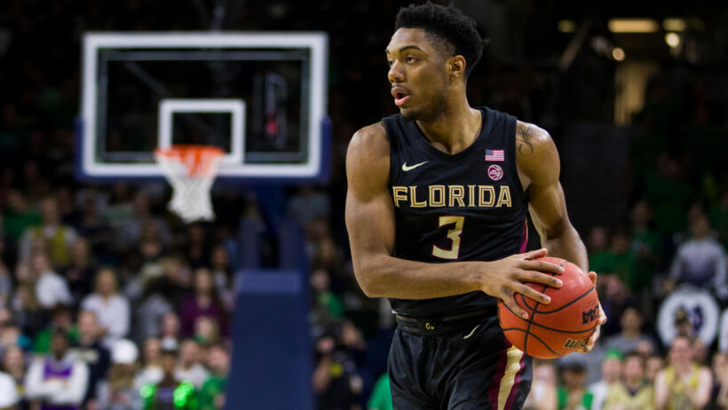 Florida State's Trent Forrest handling the ball on the court during a game.