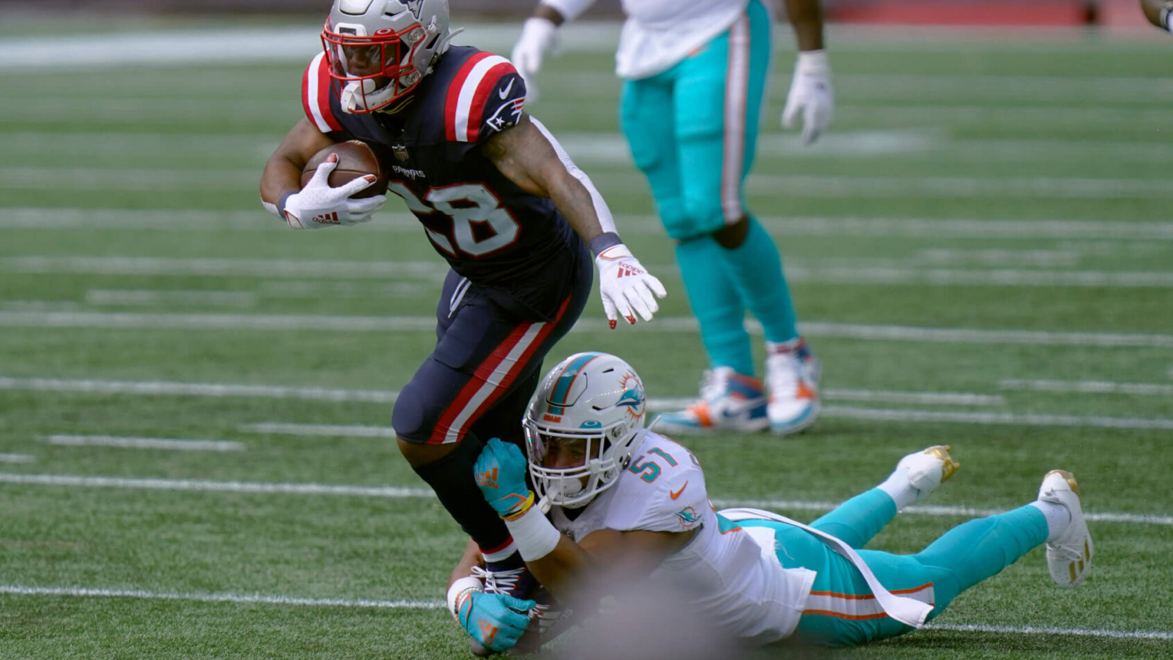 James White running while Kamu Grugier-Hill is grabbing his leg