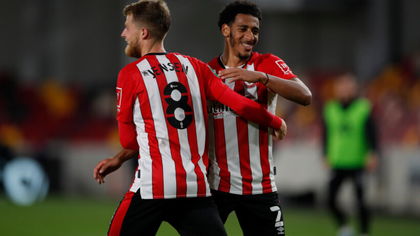 Brentford's Mathias Jensen and Dominic Thompson celebrating on the field.