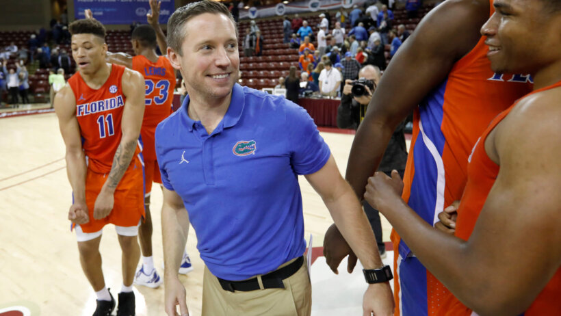 Florida head coach Mike White celebrating on the court.