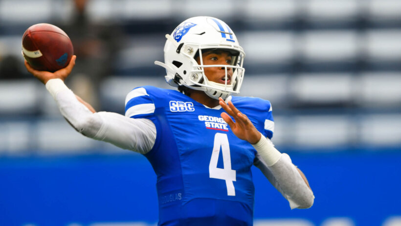 Georgia State quarterback Cornelious Brown IV throwing a pass on the field.