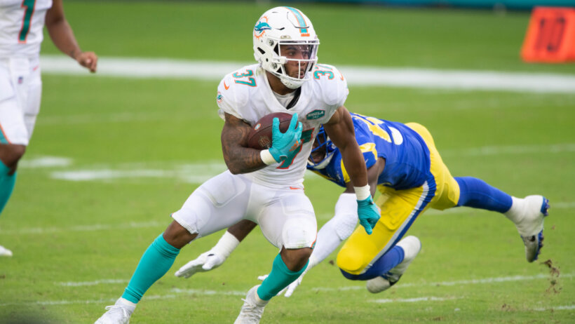 Myles Gaskin running with the football