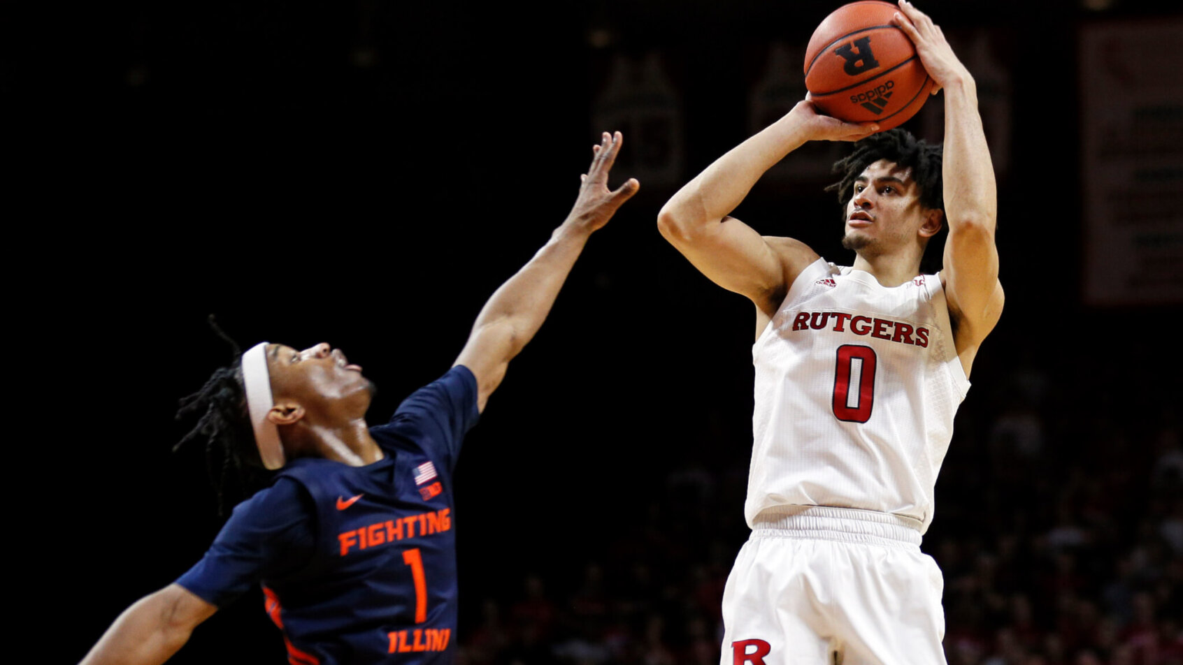 Rutgers guard Geo Baker shooting over Illinois guard Trent Frazier during a game.