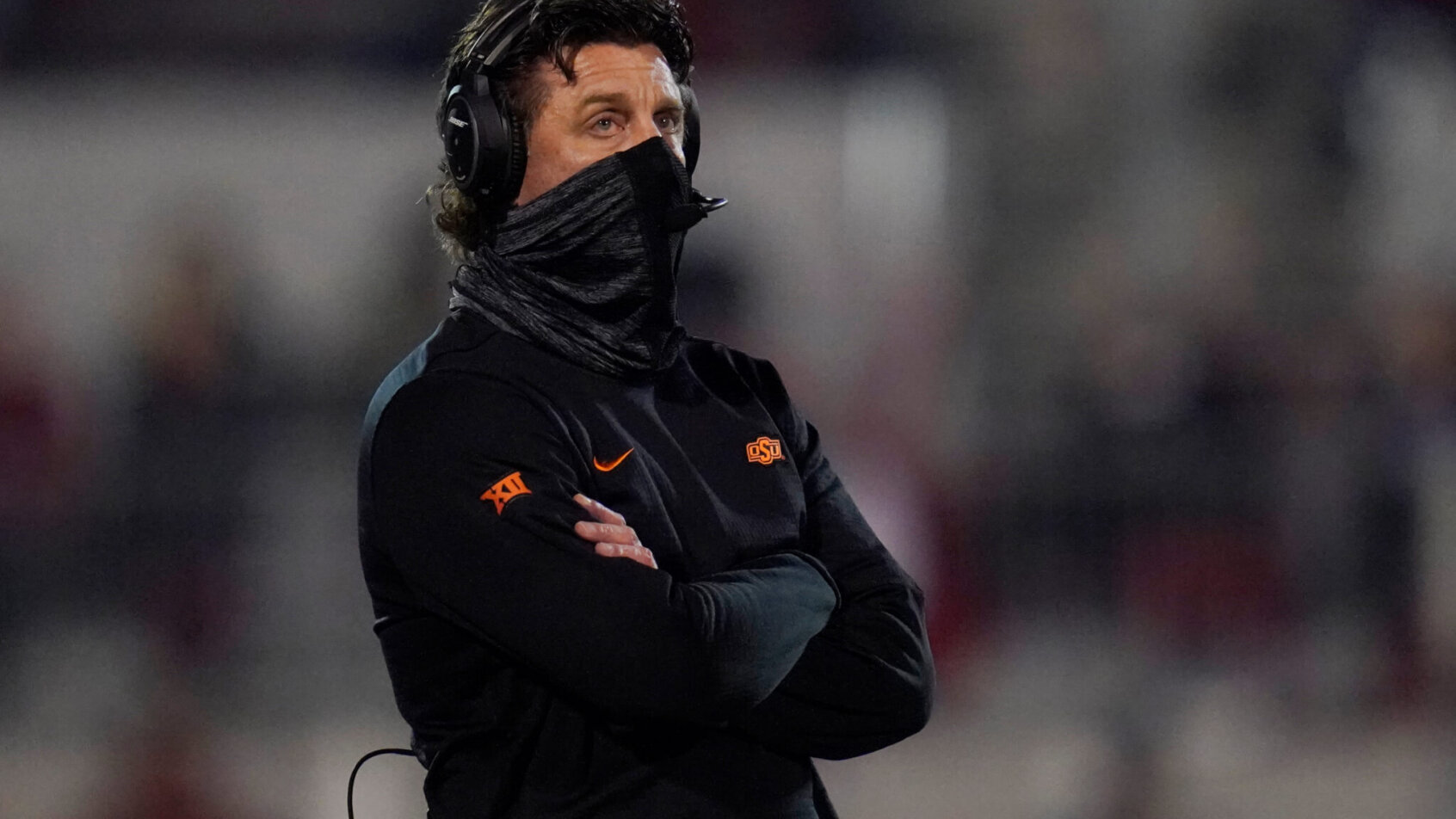 Mike Gundy standing with arms crossed