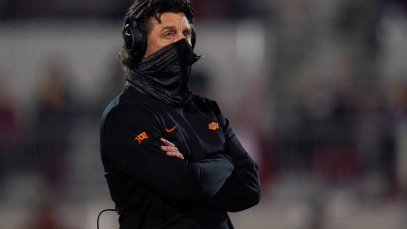 Mike Gundy standing with arms crossed