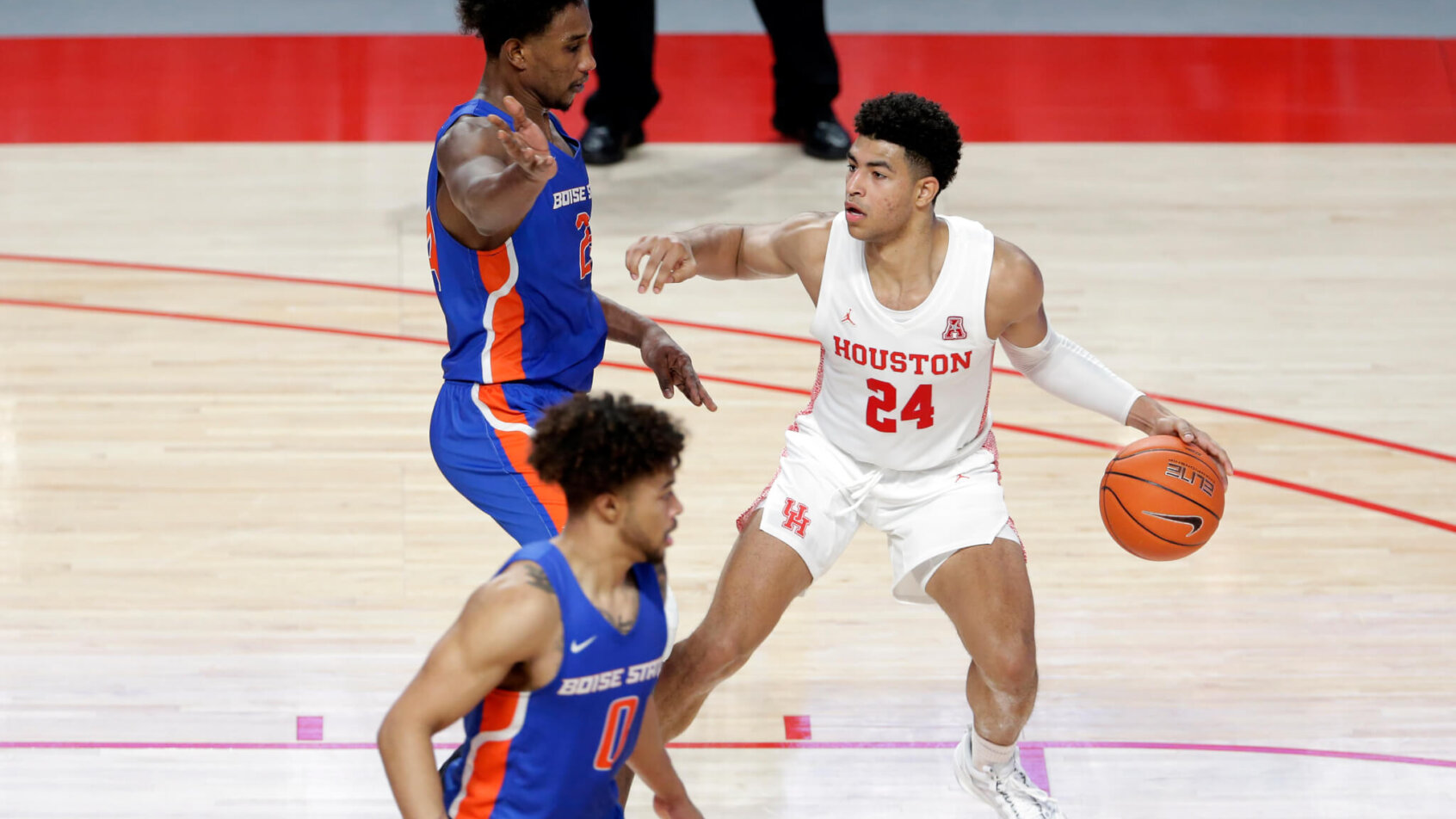 Houston guard Quentin Grimes (24) dribbling and looking to pass the ball.