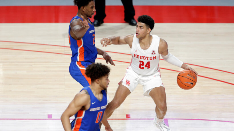 Houston guard Quentin Grimes (24) dribbling and looking to pass the ball.