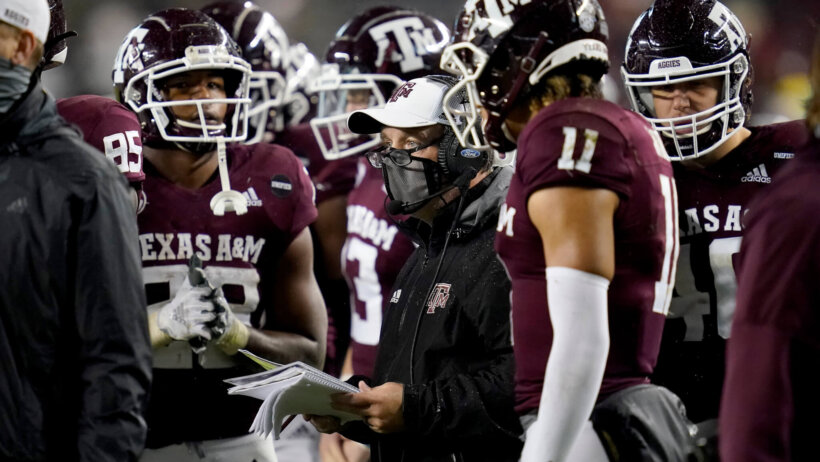 Texas A&M huddle with head coach Jimbo Fisher.
