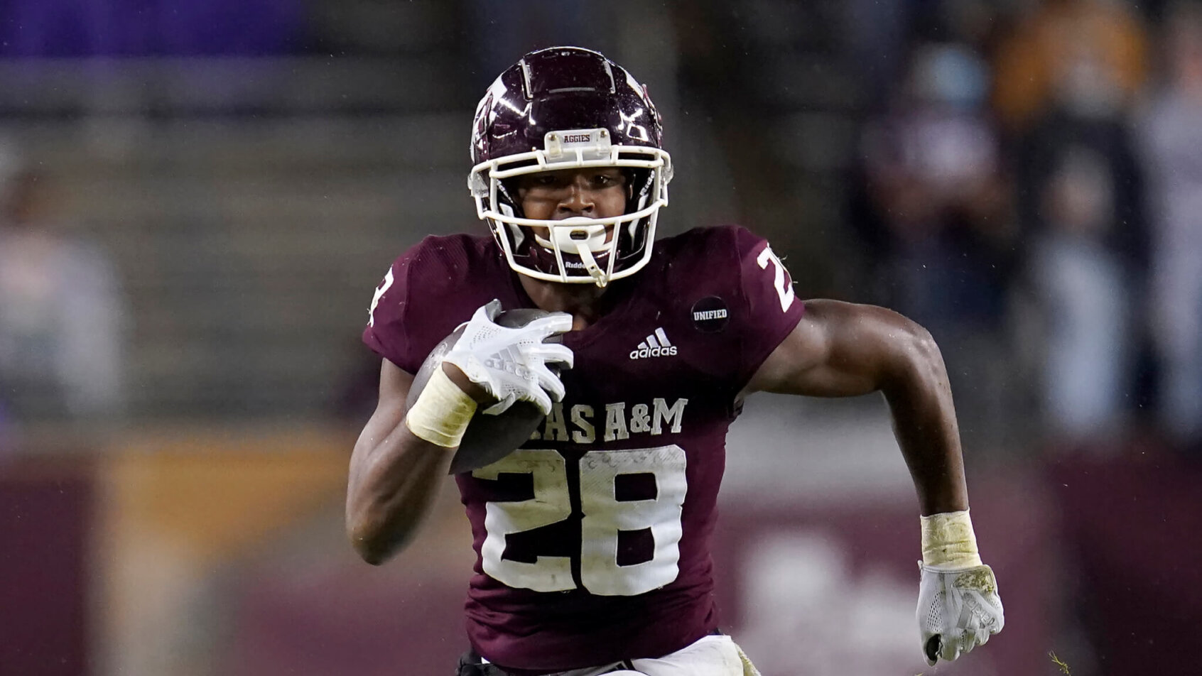 Texas A&M running back Isaiah Spiller running with the ball down the field for a first down.