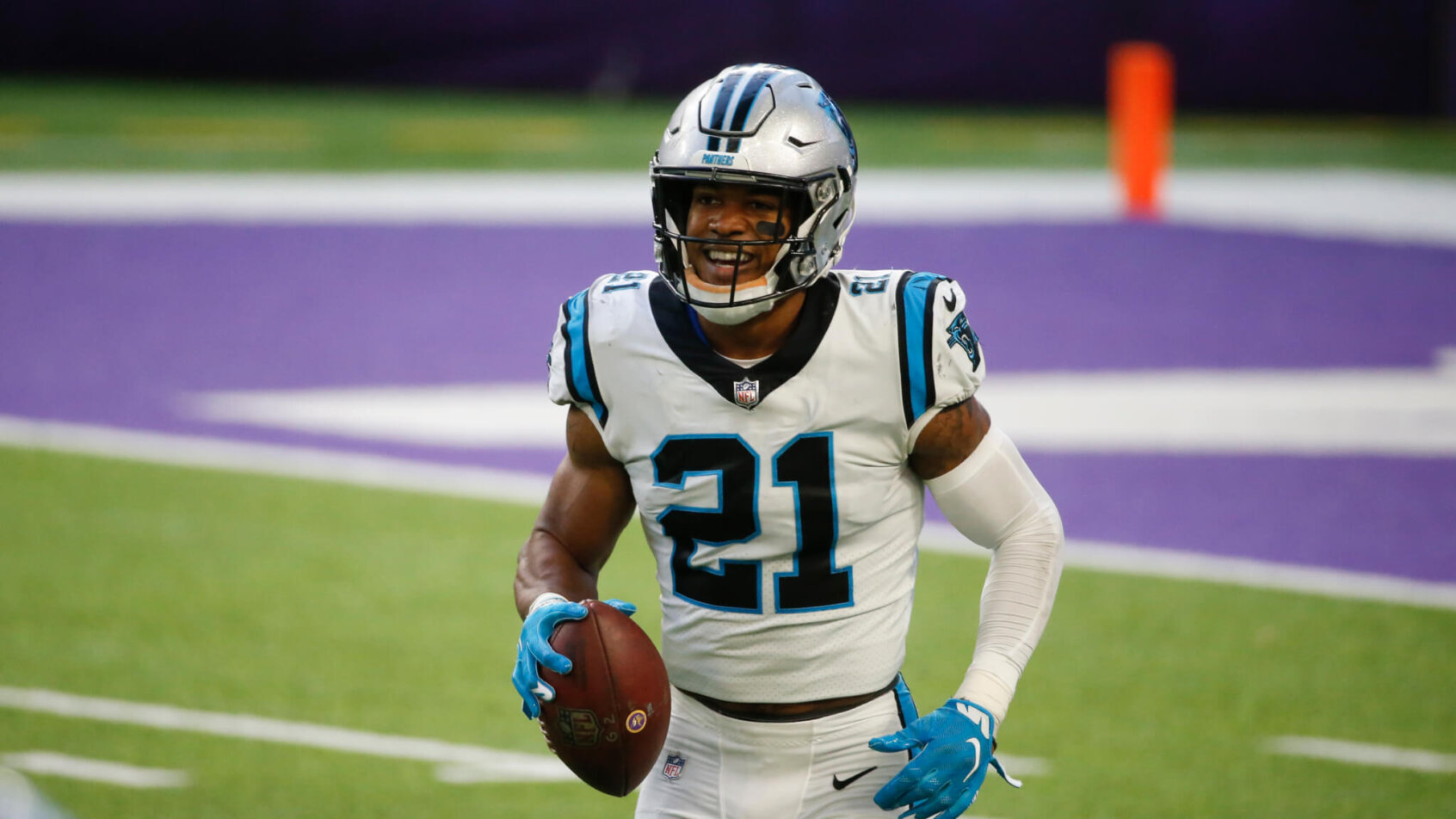 Jeremy Chinn walking with football in his right hand