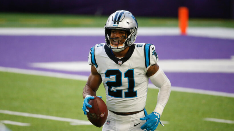 Jeremy Chinn walking with football in his right hand