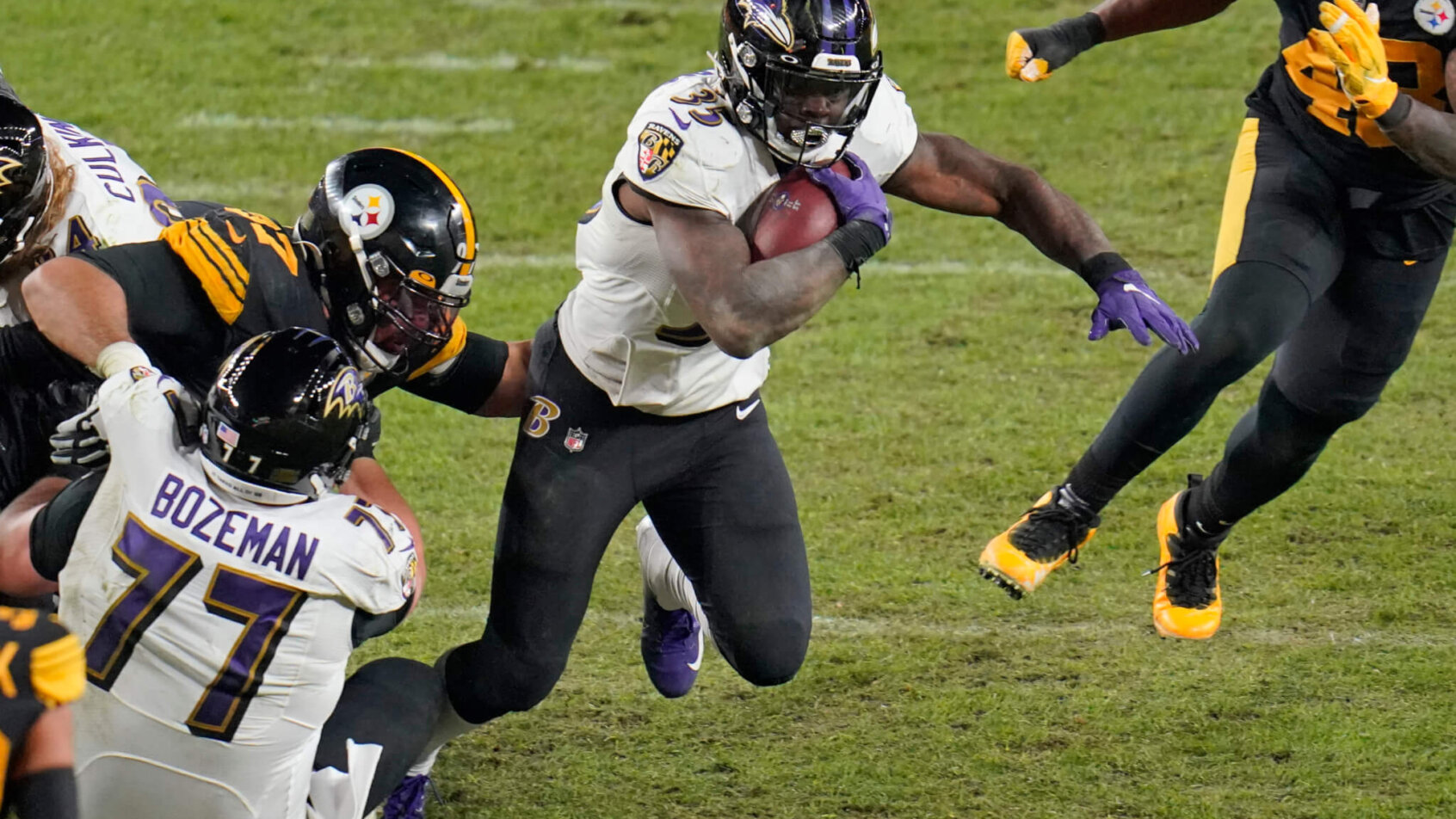 Gus Edwards carrying the ball