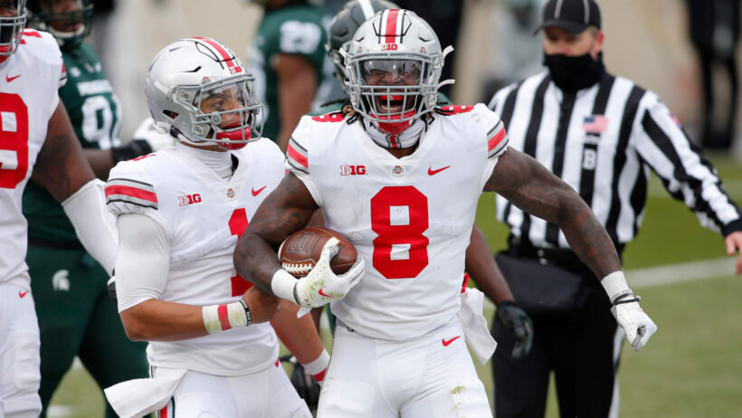 Ohio State's Trey Sermon and Justin Fields celebrate during a game.