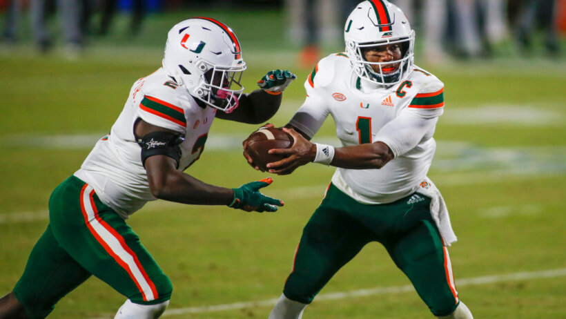 Miami quarterback D'Eriq King handing off the ball to running back Donald Chaney Jr. during a game.