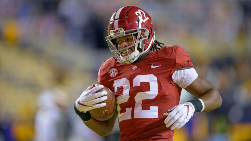 Najee Harris carrying football