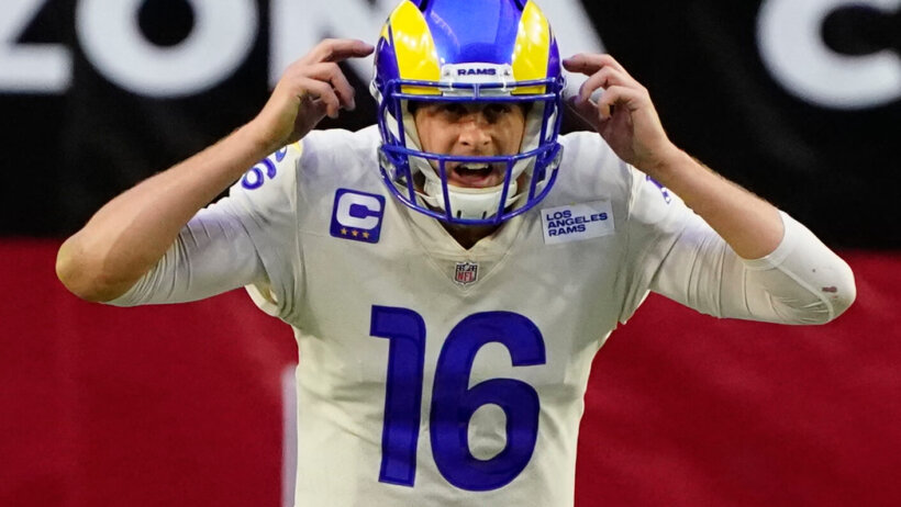 Jared Goff pointing to his helmet waiting for snap