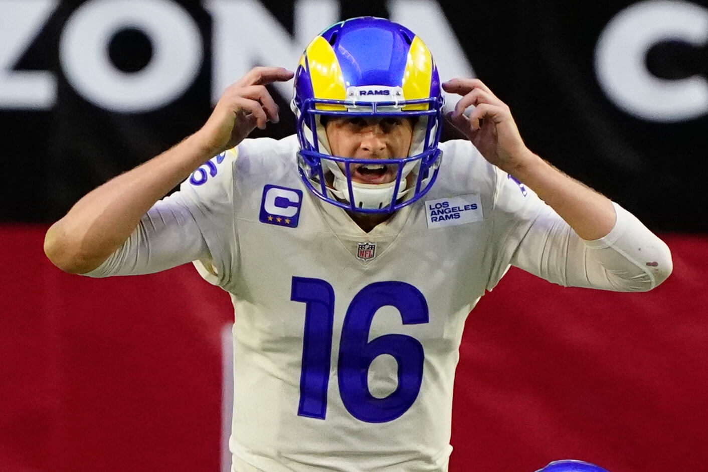 Jared Goff pointing to his helmet waiting for snap