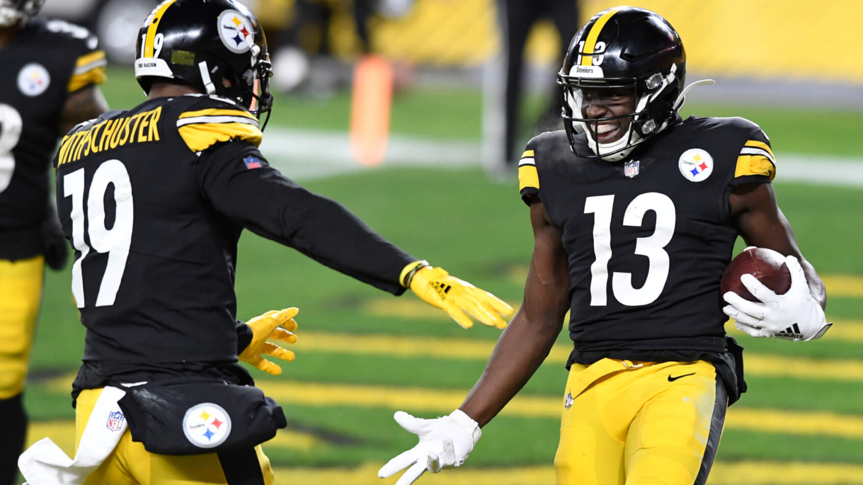 Pittsburgh Steelers wide receiver James Washington celebrates with JuJu Smith-Schuster on the field during a game.