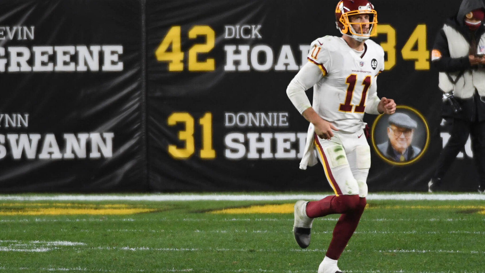 Alex Smith jogging on the field