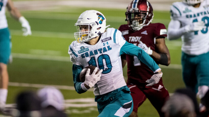 Coastal Carolina defensive back Alex Spillum running back an interception in a game.