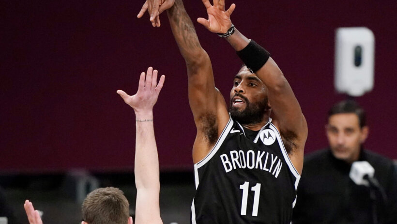 Brooklyn Nets guard Kyrie Irving shooting a jumper during a game.