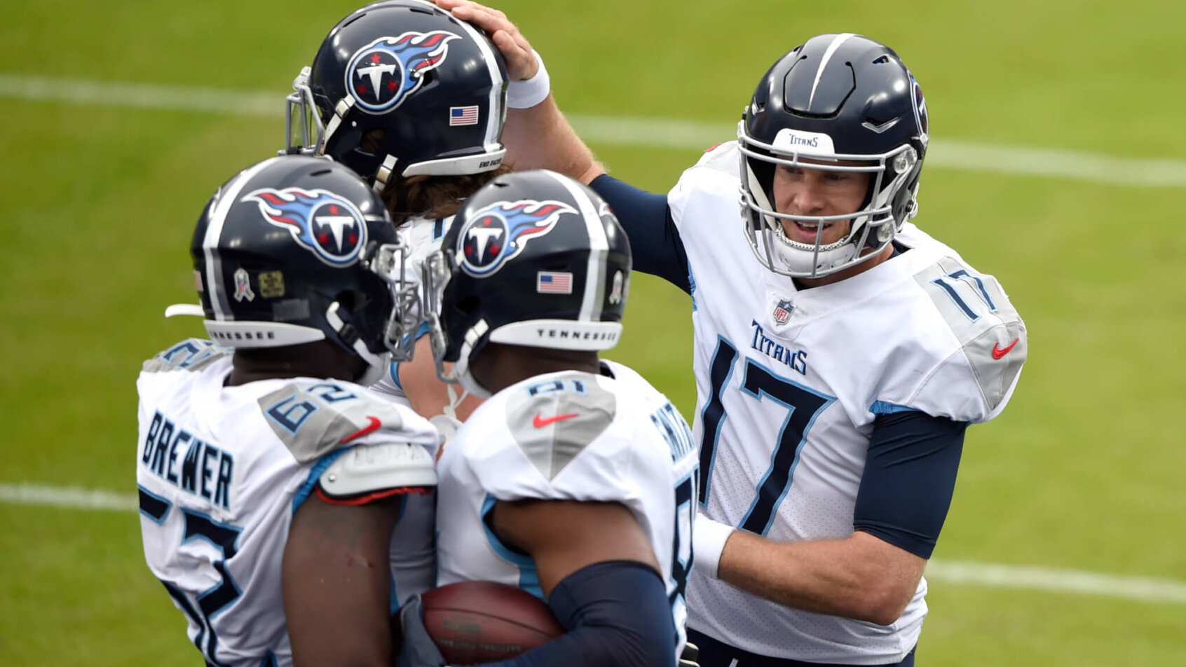 Tennessee Titans quarterback Ryan Tannehill celebrating with teammates on the field.
