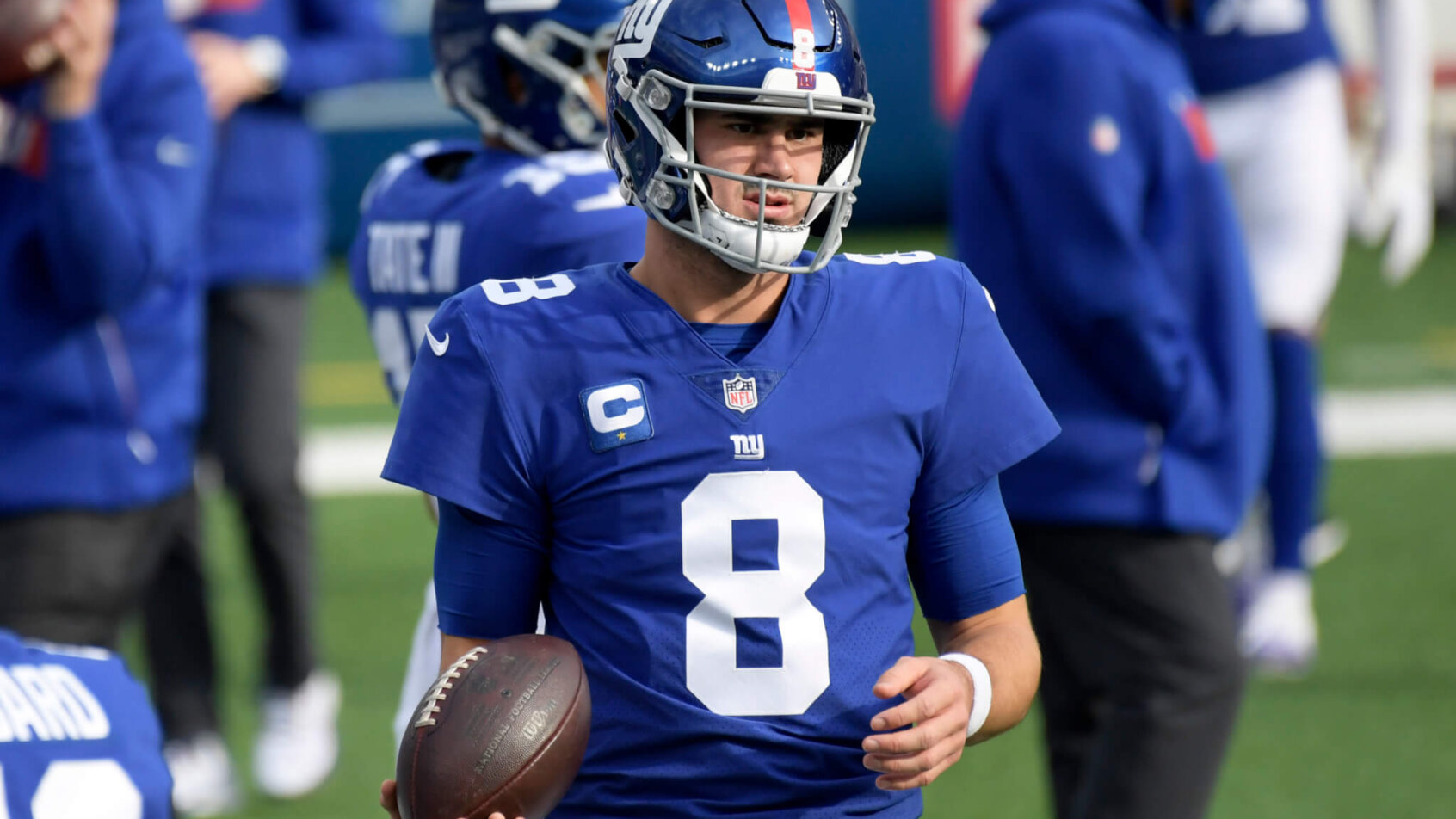 Daniel Jones holding football