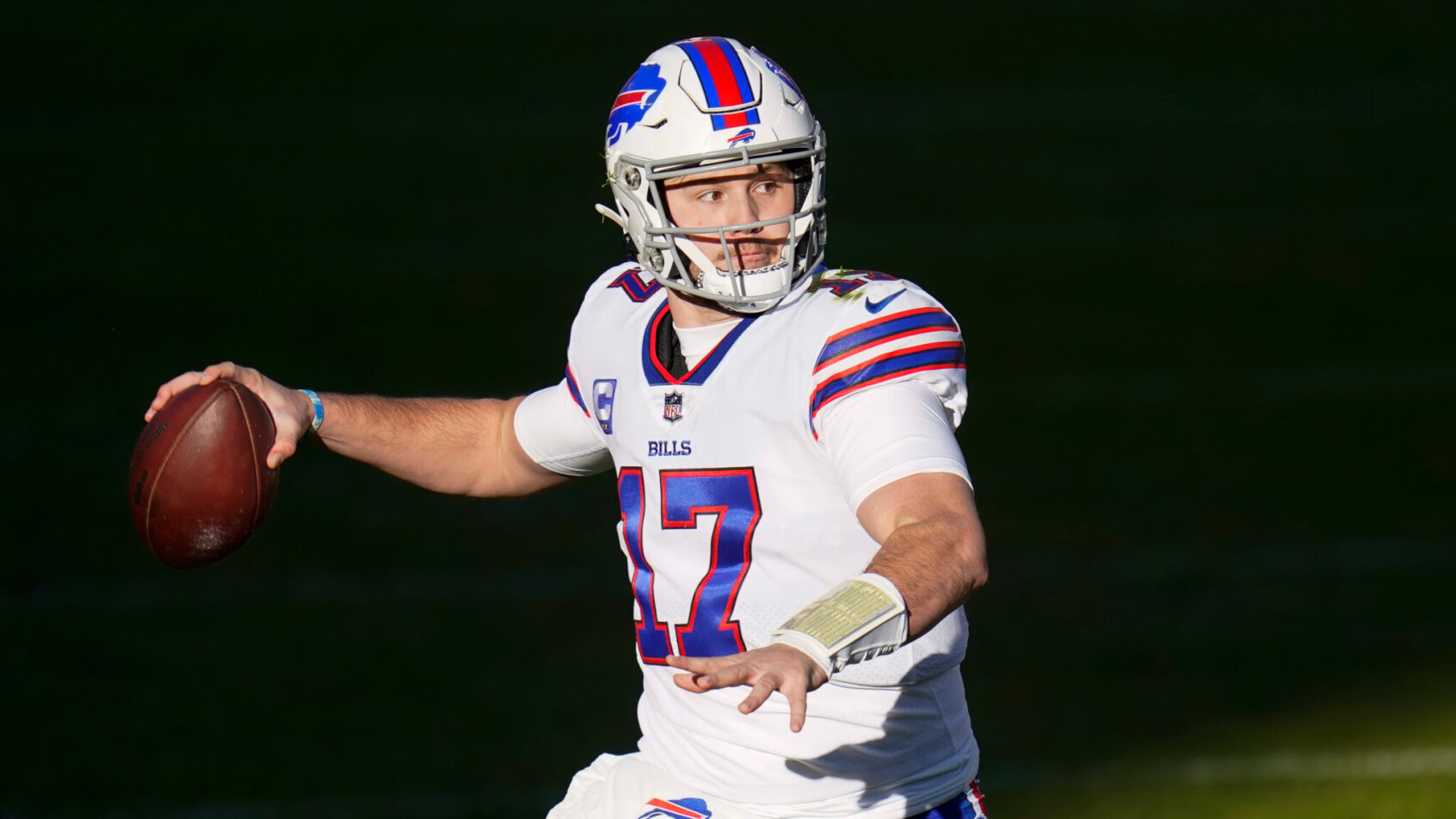 Buffalo Bills quarterback Josh Allen throwing a football during a NFL football game.