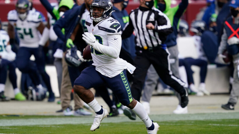 Seattle Seahawks running back Carlos Hyde running the ball during a game.