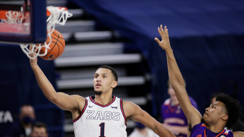 Gonzaga guard Jalen Suggs going up for a layup against Northwestern State guard Jairus Roberson