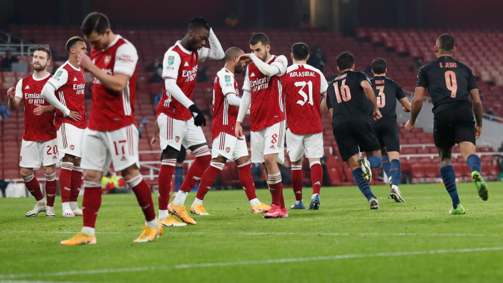 Arsenal players reacting to being scored on during a game against Manchester City