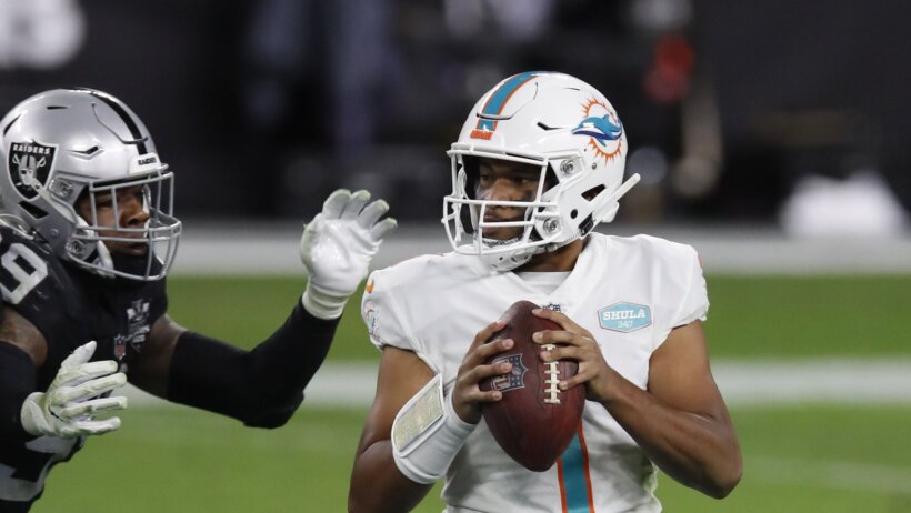 Tua Tagovailoa holding ball looking downfield in pocket